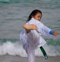 A green belt student executing a back kick at beach training in Coogee. (Feb 2016)