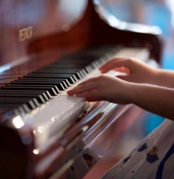 Young Child’s hand playing piano