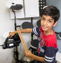 Maxx Music Boy learning drums