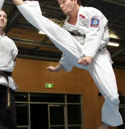 Instructors practising jumping kicks