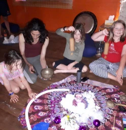 Children with hands on sound instruments at Ashtanga Yoga studio