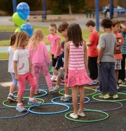 Kids use their initiative to step into a hoop that nobody is in.  Its also a game of sharing and caring for your friends.