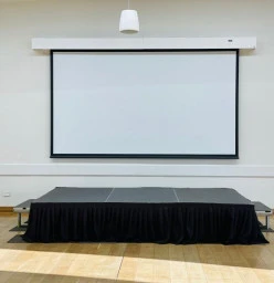 stage with a projector screen on wall