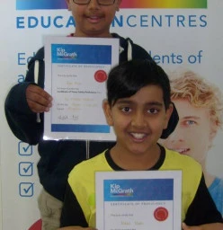 Ryan and Nikhil proudly show off their Times Tables Proficiency Certificates
