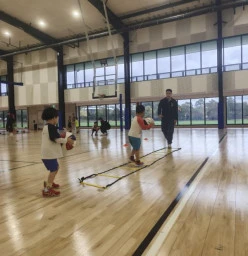 Kids practicing basketball drills with cones and balls at First Pick Basketball training in Melbourne