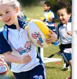 Young girl holding rugby ball