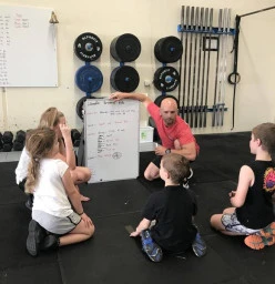 CrossFit Kids listening to what they are going to be doing.