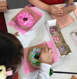 Kids make clay art doughnuts and sprinkle confetti paper, inspired by pop artist Wayne Thiebaud