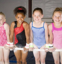 Gymnastics girls on bar in front support