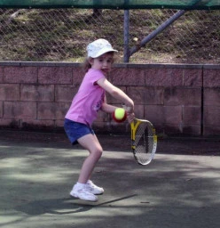 Shire pupil 4 year old Chloe prepares to fire down a topspin backhand