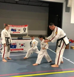 Young students getting one on one instruction from Master Instructor for Australia Jerry